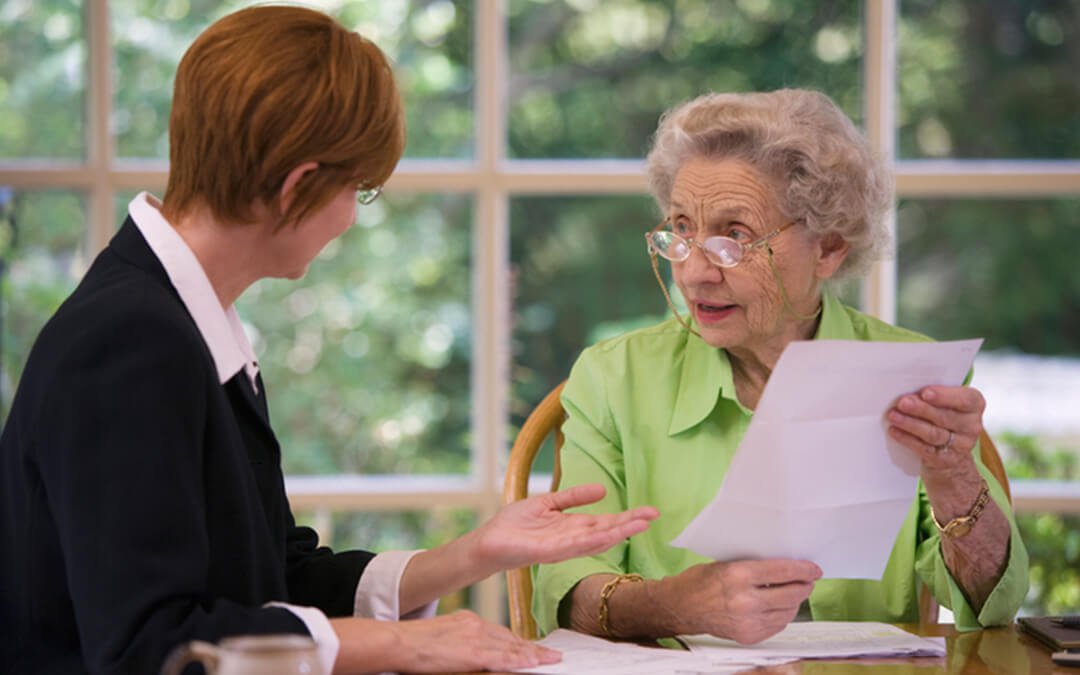senior woman meeting with agent - how to be self advocate in autism community financial planning