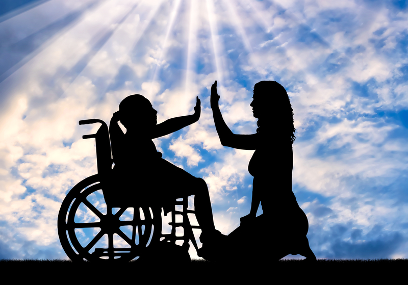 woman high fiving daughter in wheelchair