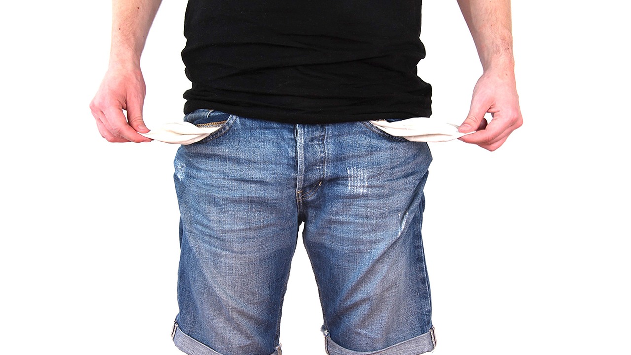 man with hands showing empty pockets