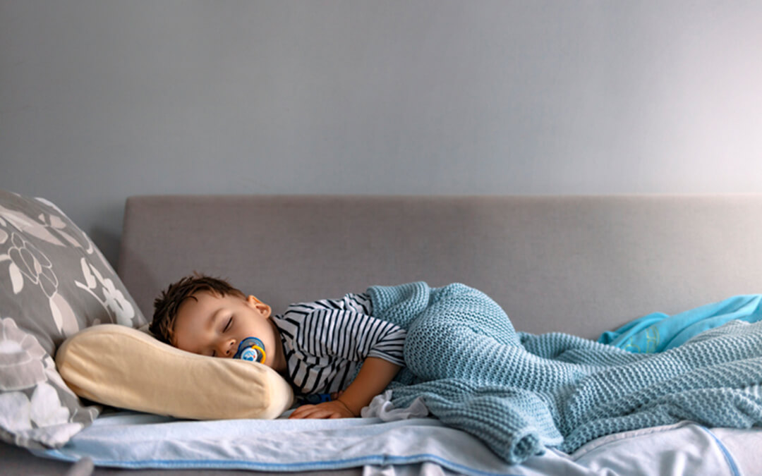 child sleeping in bed - helping your autistic child get a better nights sleep