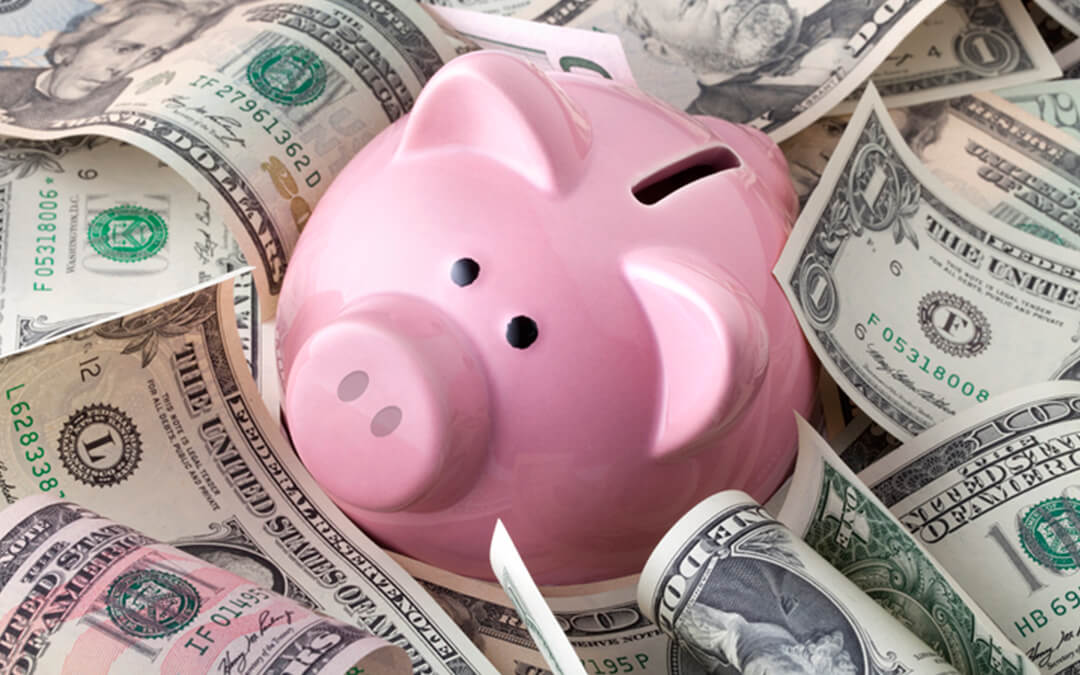 piggy bank on dollar bills - an introduction to able accounts financial planning with special needs