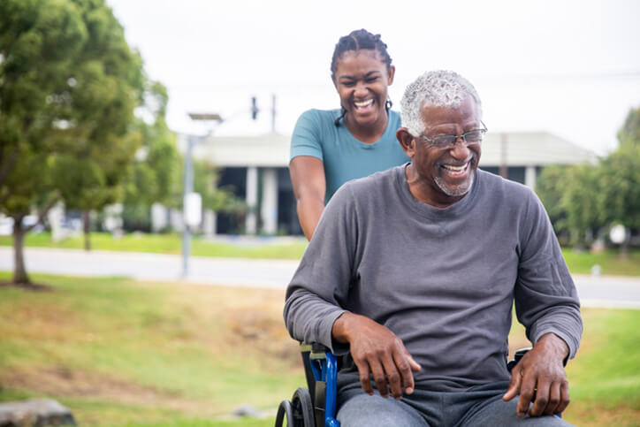 black man in wheelchair with daughter - certified neurodiverse financial planning services