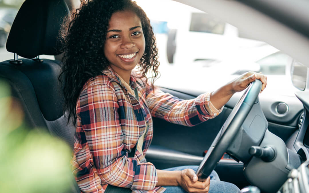 millennial girl driver behind wheel of car - seven things to help autistic teens drive