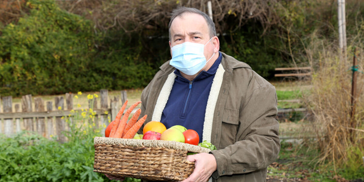 man working outside with mask on - neurodiverse employer benefit planning services