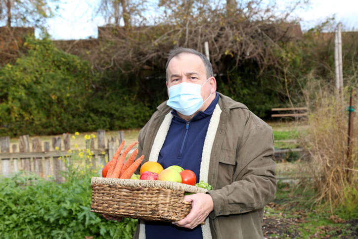 man working outside with mask on - neurodiverse employer benefit planning services