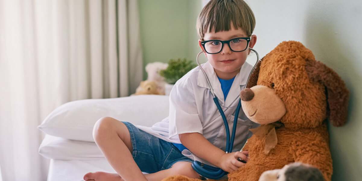 kid playing doctor with teddy bear - neurodiverse autism financial planning services farmington ct