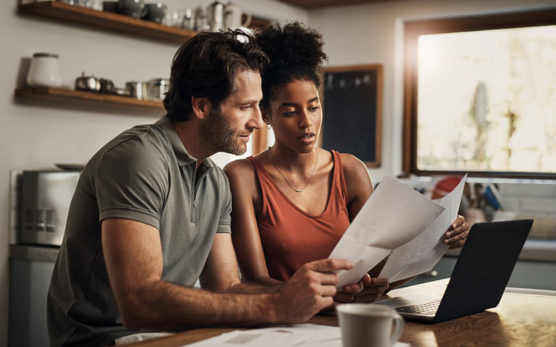 mixed couple reviewing expenses - five practical uses for able account certified financial planning