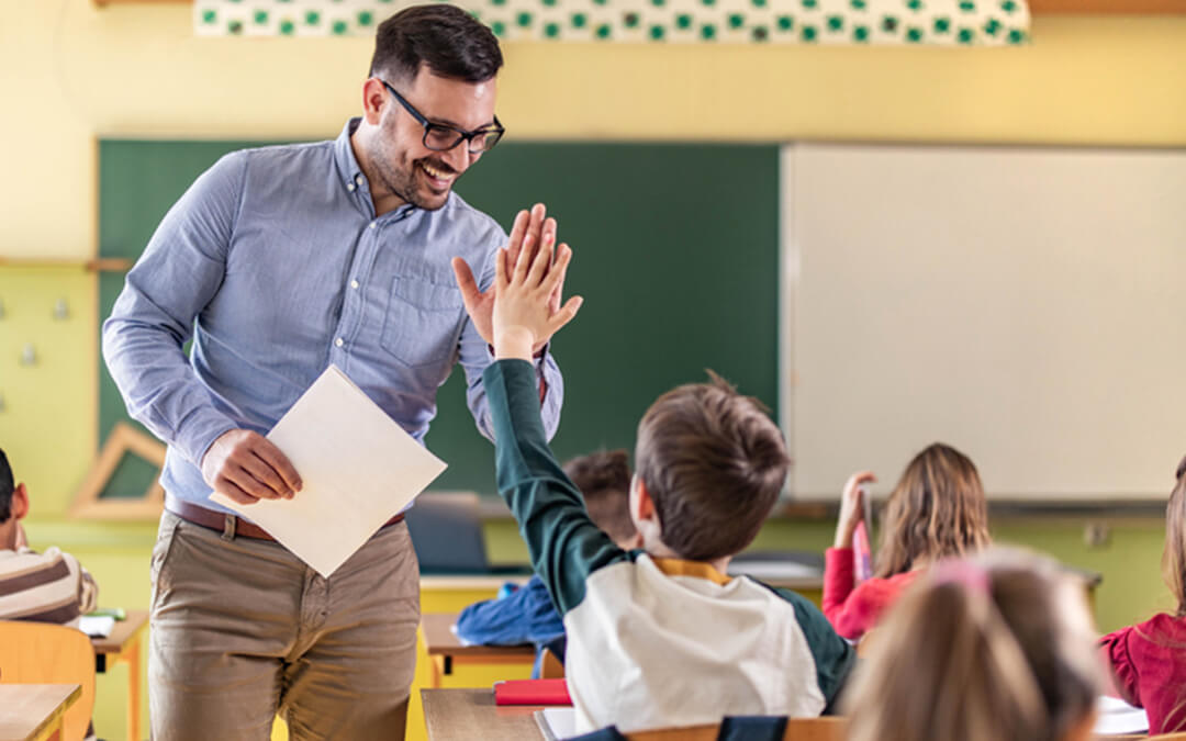 teacher high five student in class - how to stop using special needs functioning labels