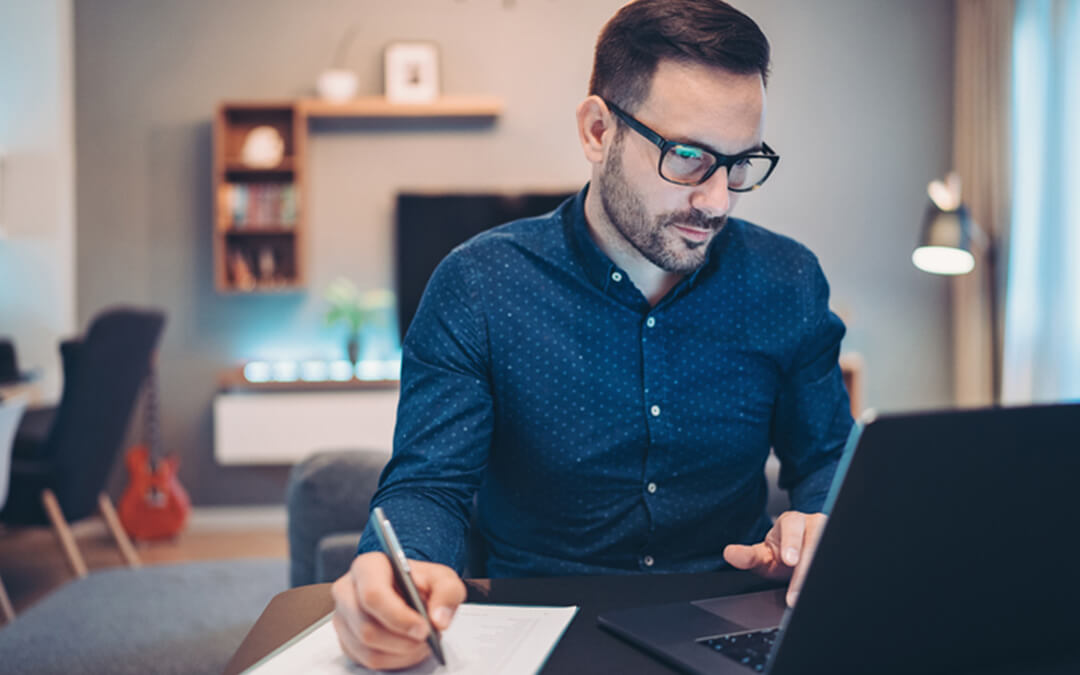 man at desk looking at computer - what is a special needs advisor? - financial planning services