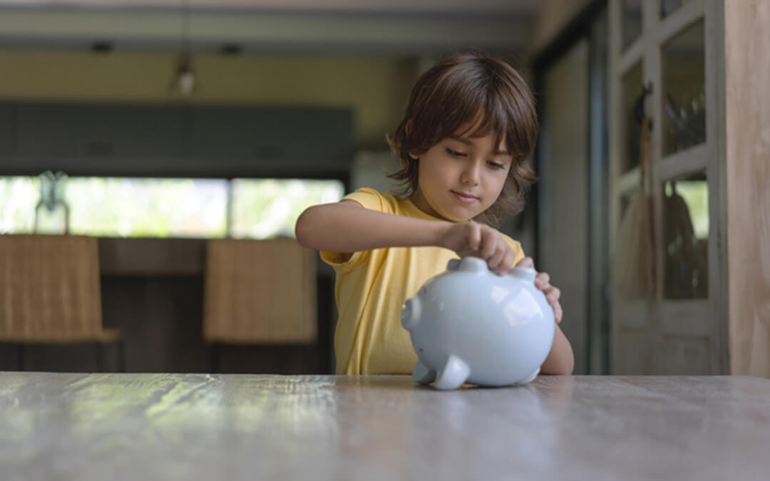 small boy coins in piggy bank - who can open an able able account certified financial planning